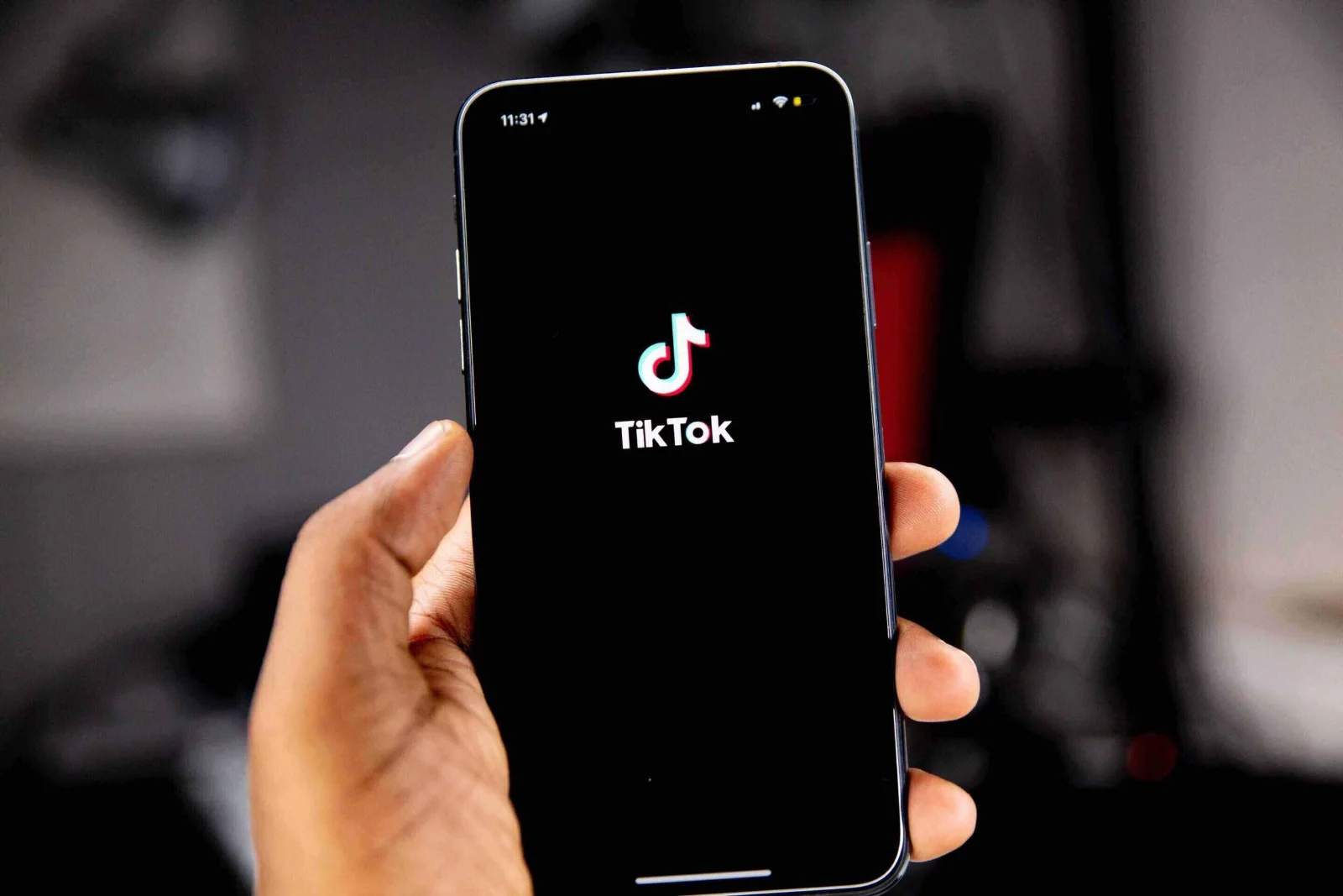 Young woman creating a TikTok video on her phone, highlighting modern recruitment methods