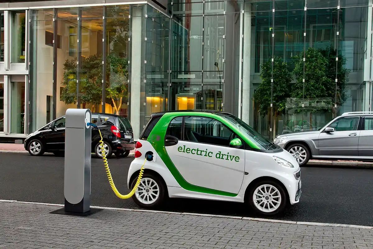 Electric car charging cable connected to a vehicle, symbolizing the rise of EVs
