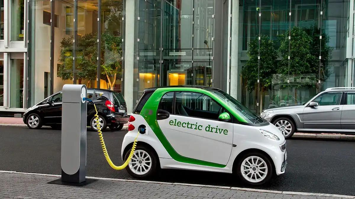 Electric car charging cable connected to a vehicle, symbolizing the rise of EVs