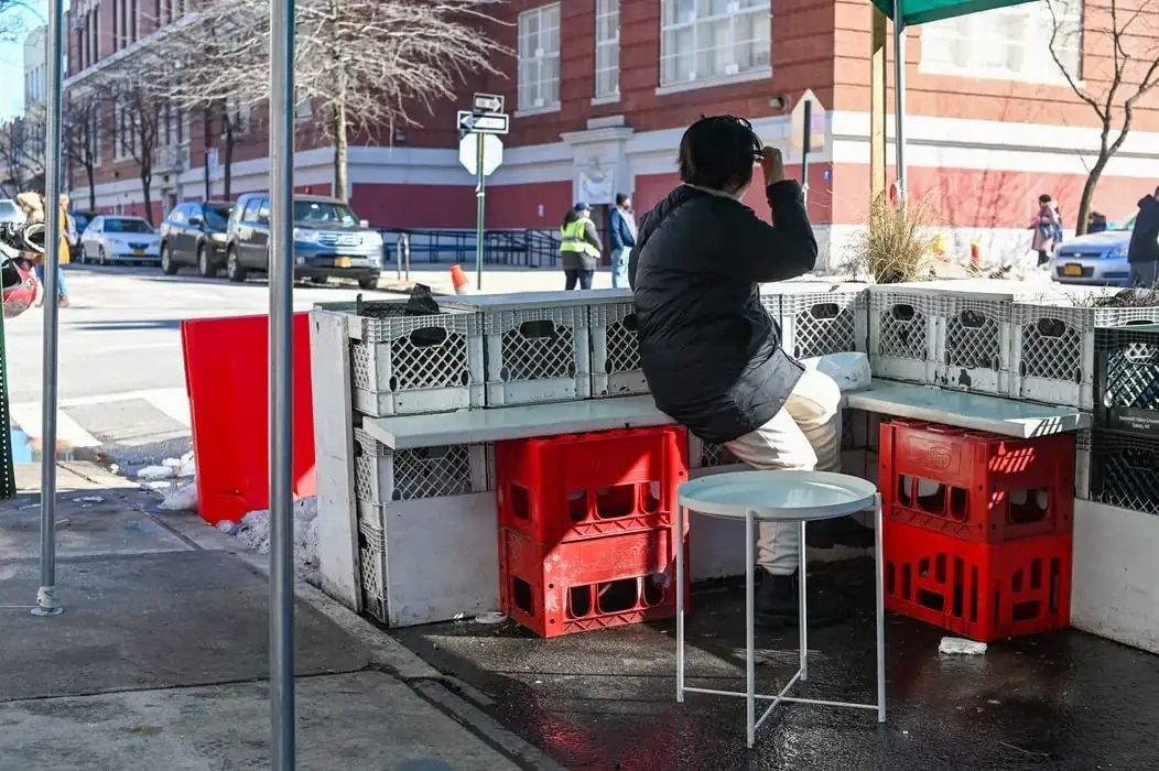 Stack of milk crates collapsing, illustrating the viral social media challenge danger
