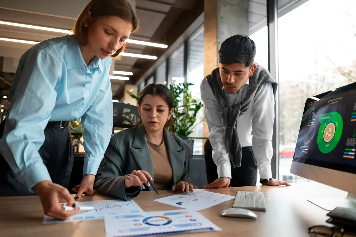 Diverse team in a bright office, collaborating on a challenging marketing strategy
