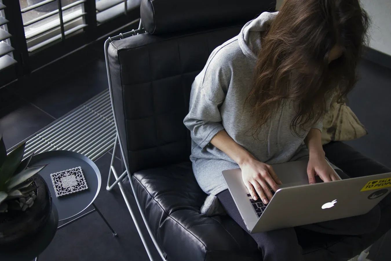 Remote worker typing on a laptop, enjoying a flexible and modern work environment