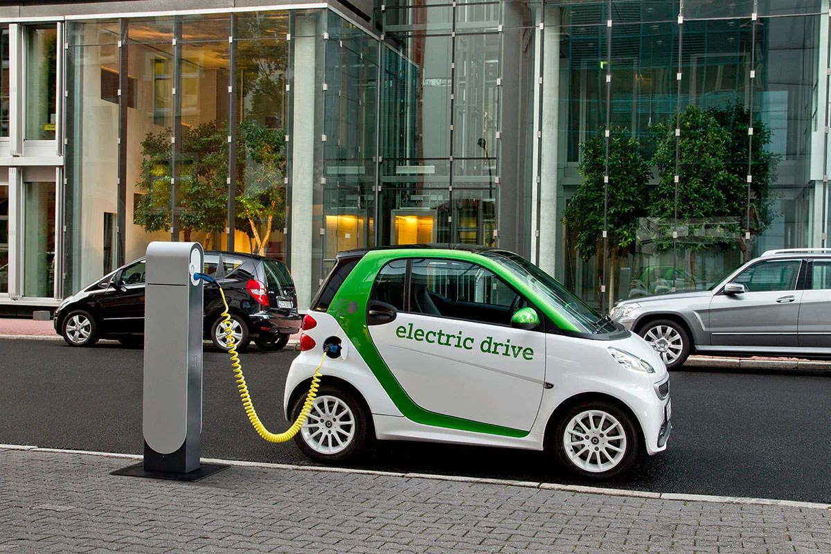 Electric car charging cable connected to a vehicle, symbolizing the rise of EVs
