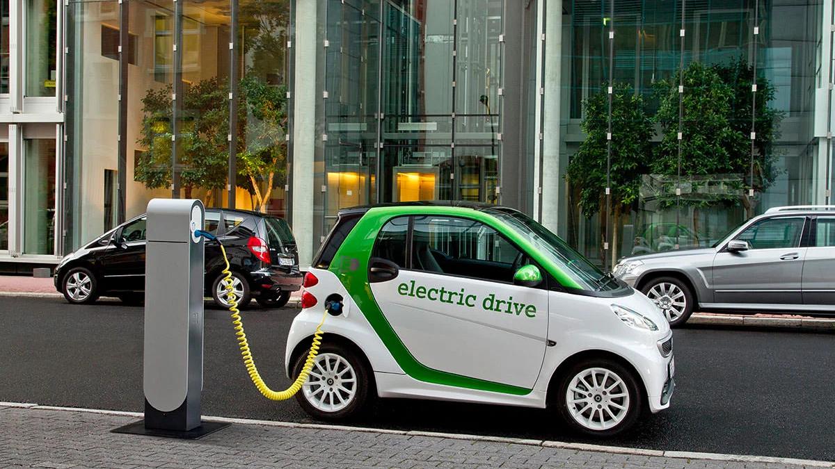 Electric car charging cable connected to a vehicle, symbolizing the rise of EVs