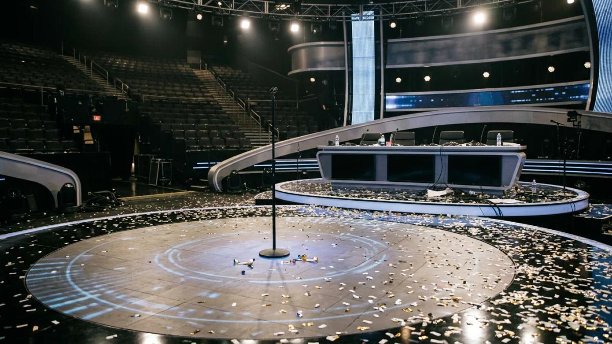 A spotlight shines on an empty stage, symbolizing the end of an American Idol era