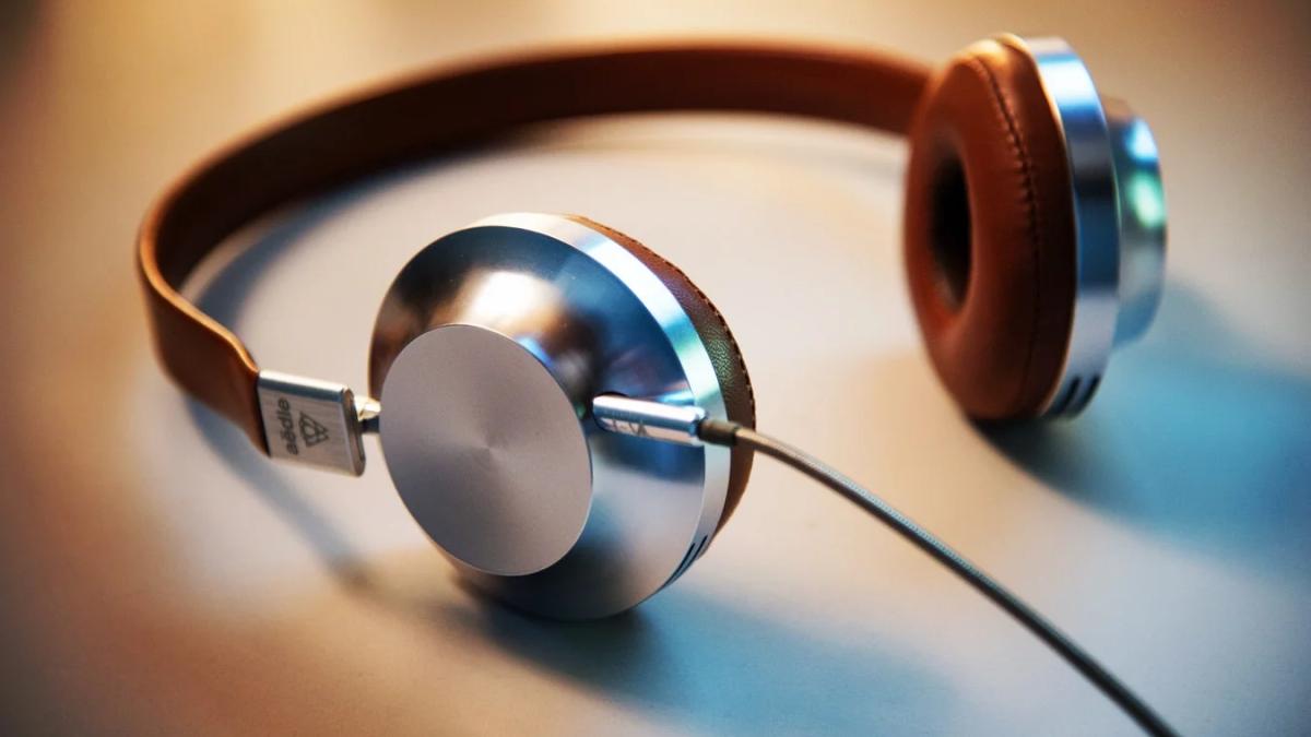 Colorful sound waves and headphones illustrate creative audio marketing strategies