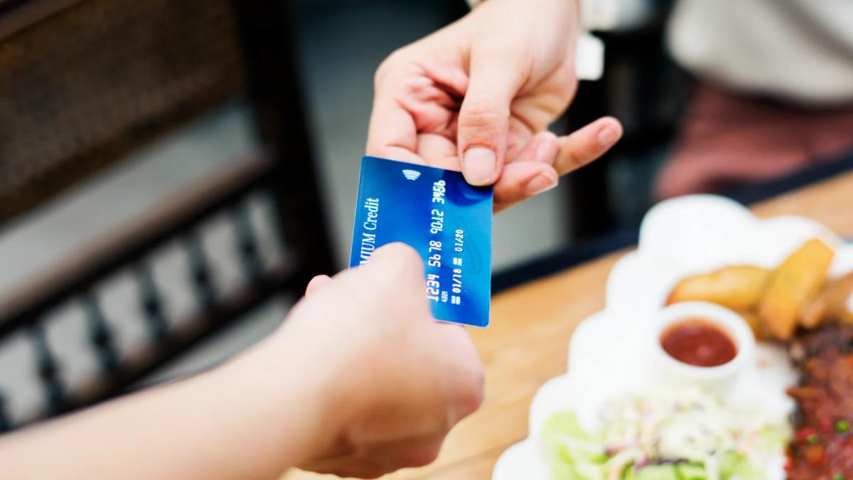 Worried bank customer reviewing account statements, highlighting the increase in financial scams