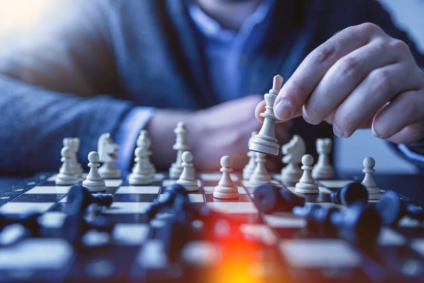 Woman strategically placing chess pieces on a board, adapting to market trends