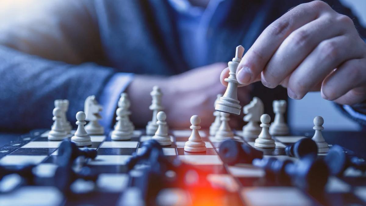 Woman strategically placing chess pieces on a board, adapting to market trends