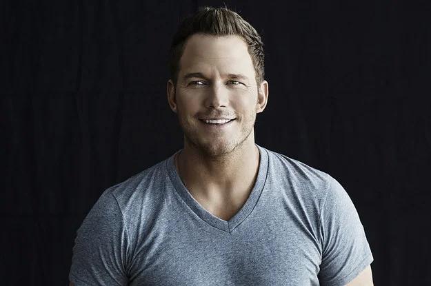 Chris Pratt smiling, posing with a bottle of Michelob Ultra beer