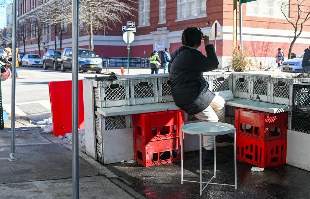 Stack of milk crates collapsing, illustrating the viral social media challenge danger