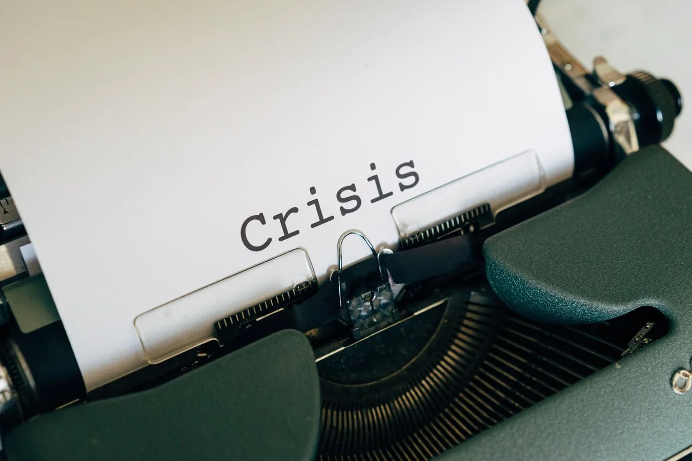 Person awakening to an alarm clock, illustrating the sudden start of a crisis