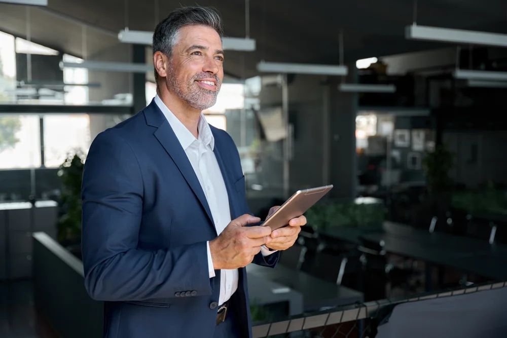 Leader using a magnifying glass to examine a clear roadmap for executive visibility