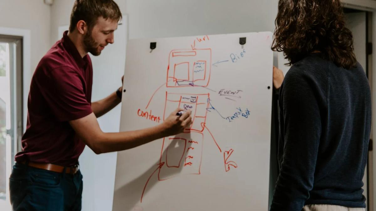 A businessperson studies data on a transparent screen, optimizing a digital strategy