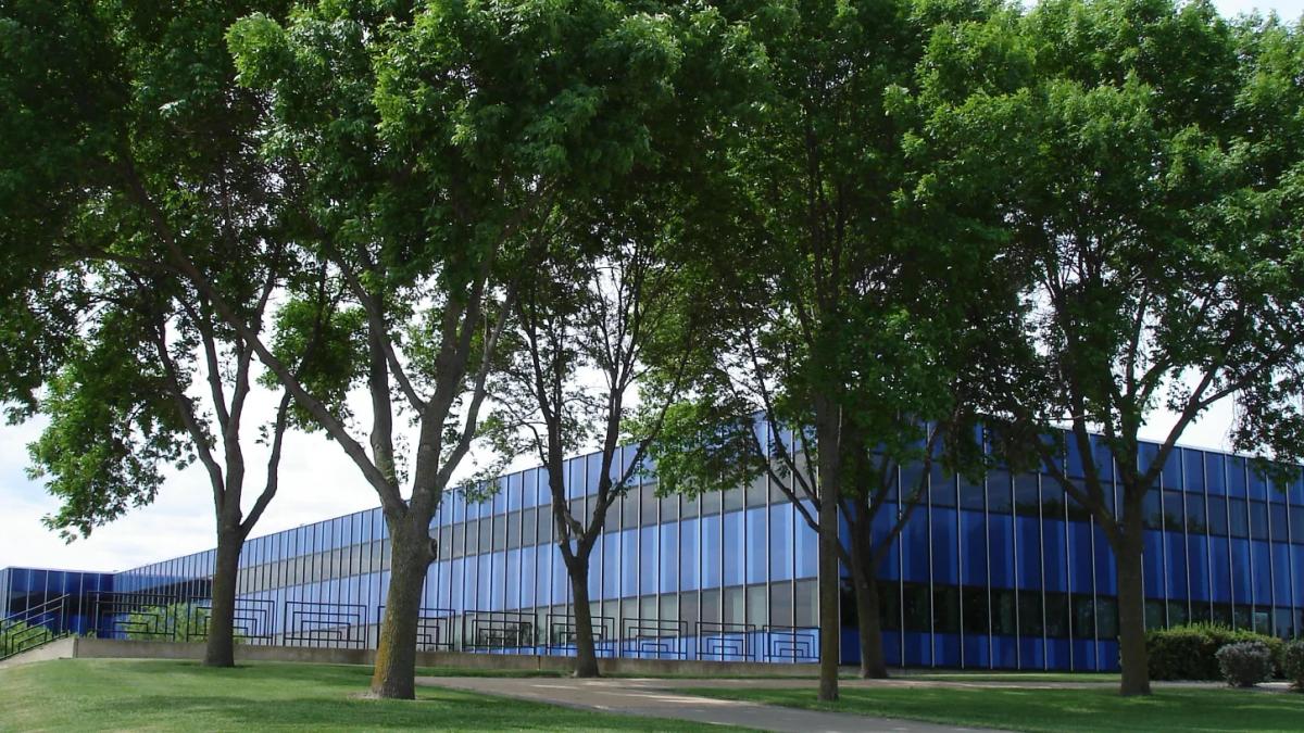 IBM logo with blurred employees working in a modern office environment