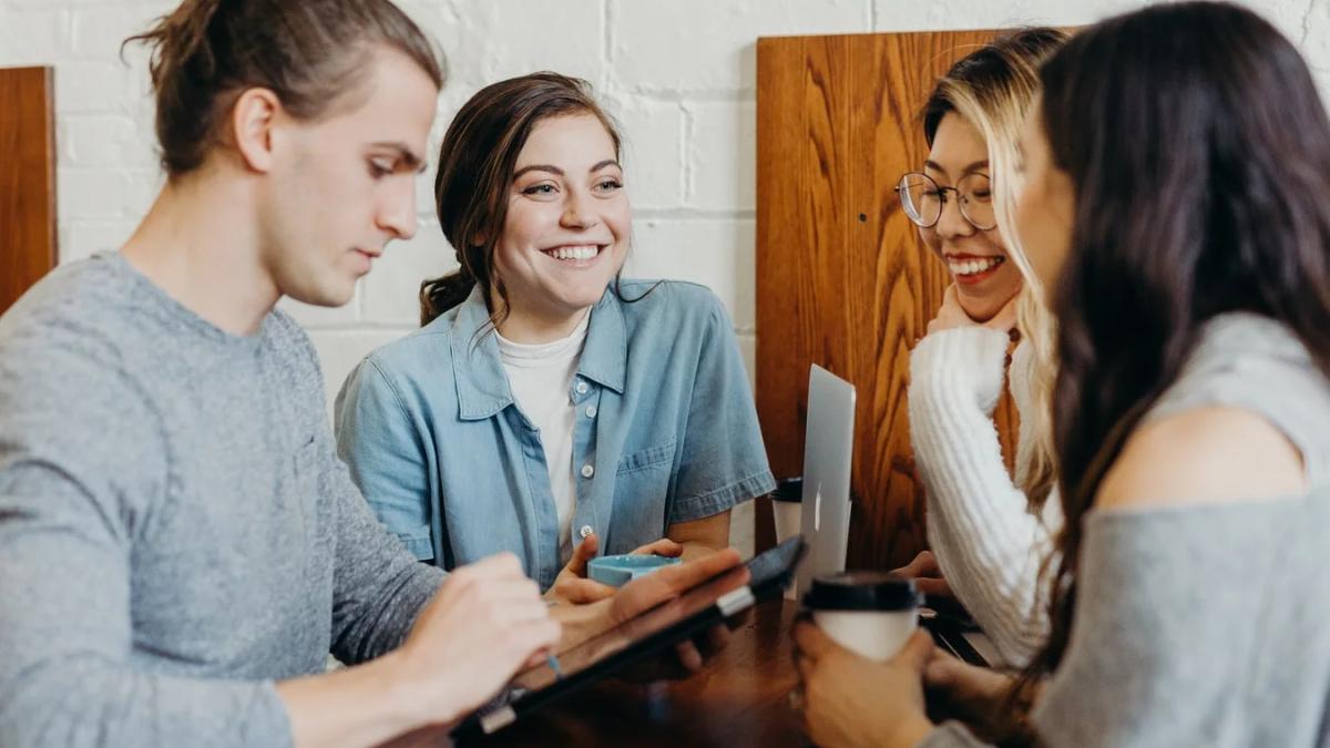 A diverse team of business professionals collaborating and communicating in an office setting