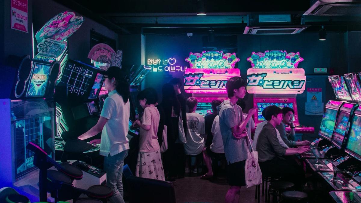 Girls dancing in formation on stage with bright lights, a dynamic K-pop performance
