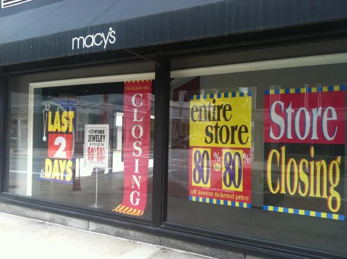 Empty Macy's store front in a deserted mall corridor, signaling retail decline