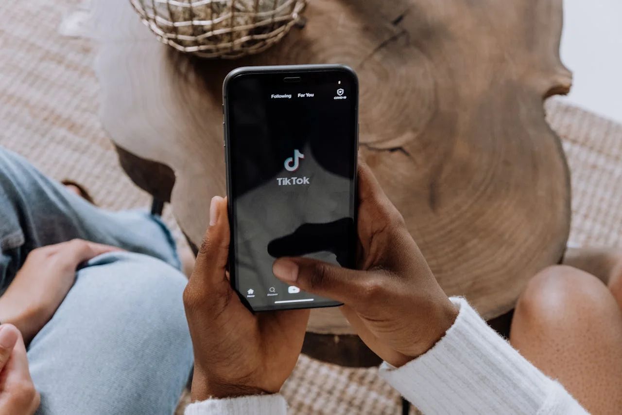 Man scrolling TikTok on phone, effective marketing to men strategy