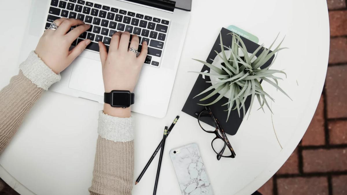 Marketers look glumly at a burnt-out marketing strategy on a scorched laptop