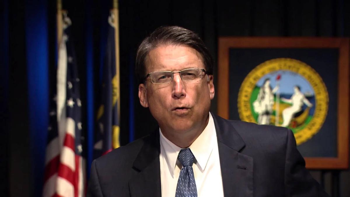 Pat McCrory at a podium speaking to an audience, reinventing his brand