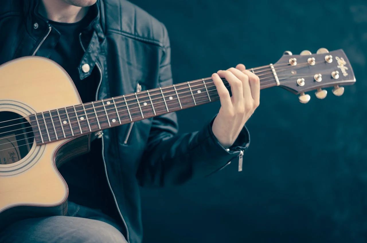 Musician performs on stage, vibrant lights, crowd cheering, reflecting effective music marketing