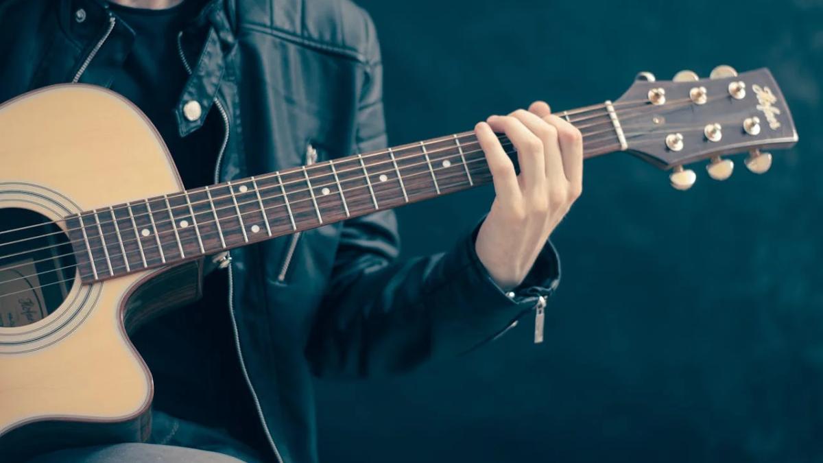 Musician performs on stage, vibrant lights, crowd cheering, reflecting effective music marketing