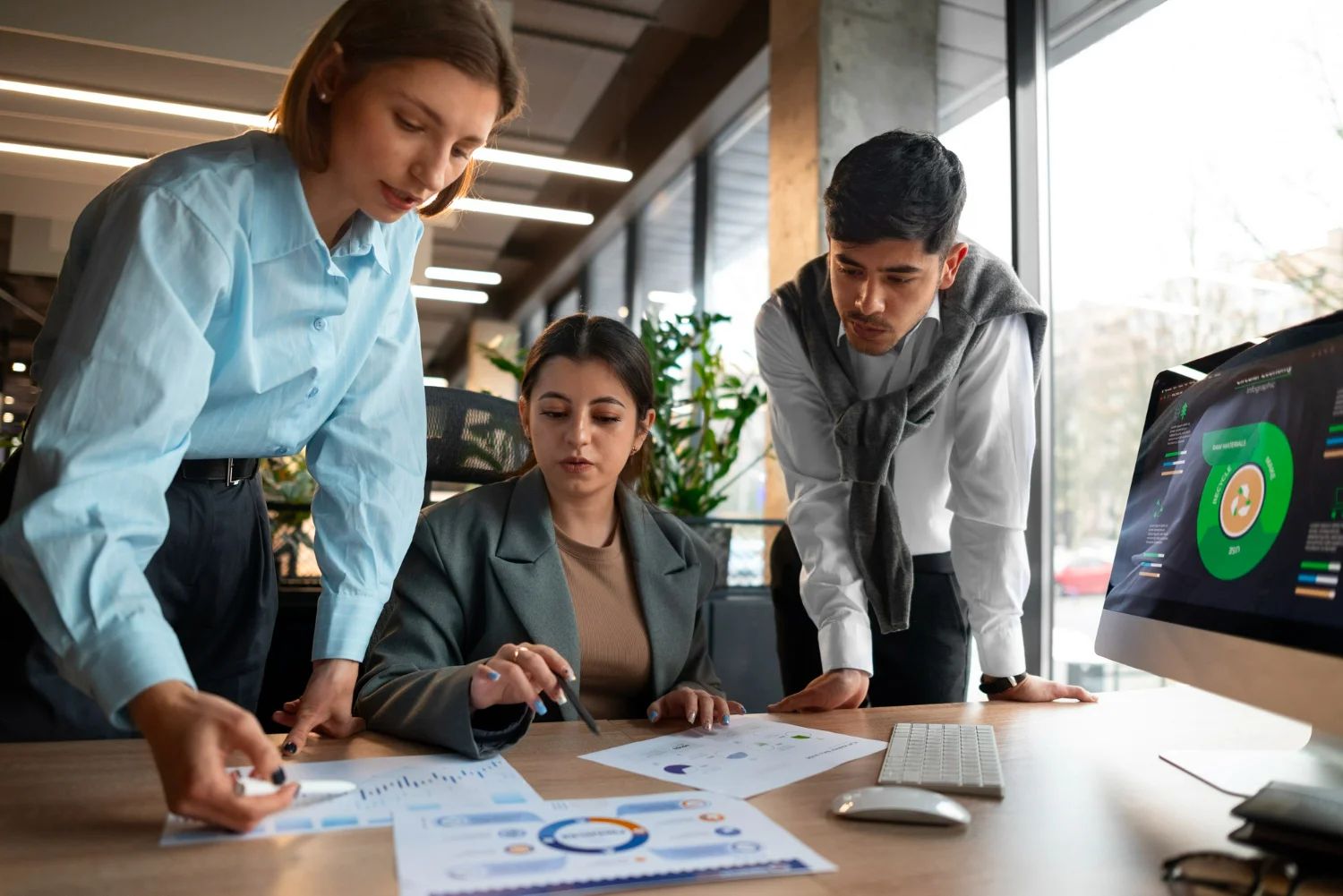 Diverse team in a bright office, collaborating on a challenging marketing strategy