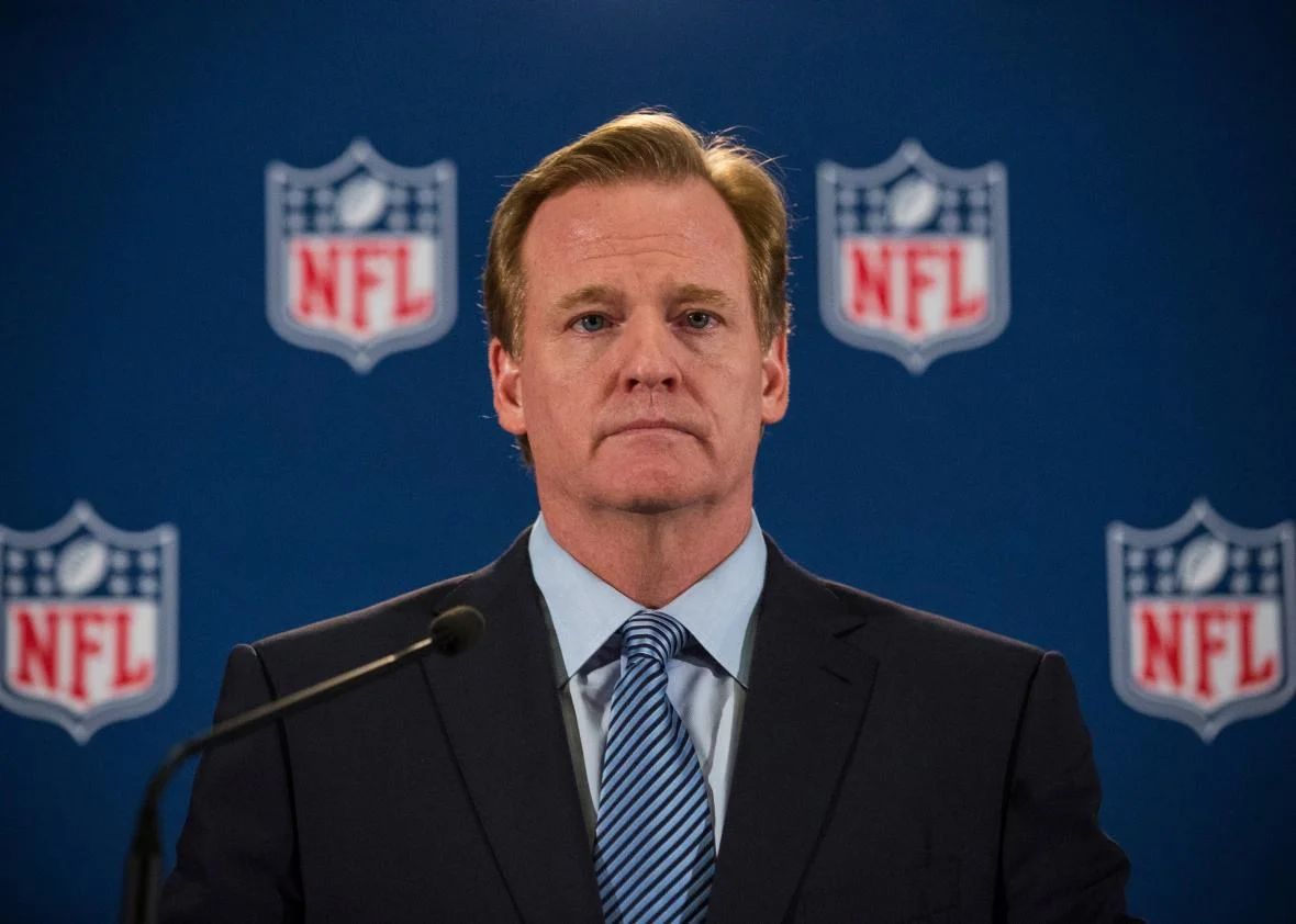 Jerry Jones staring intently at Roger Goodell, NFL commissioners meeting in conflict