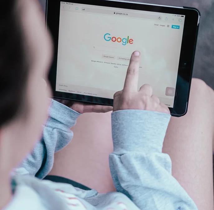 Two magnifying glasses, one blue and one orange, analyzing search results