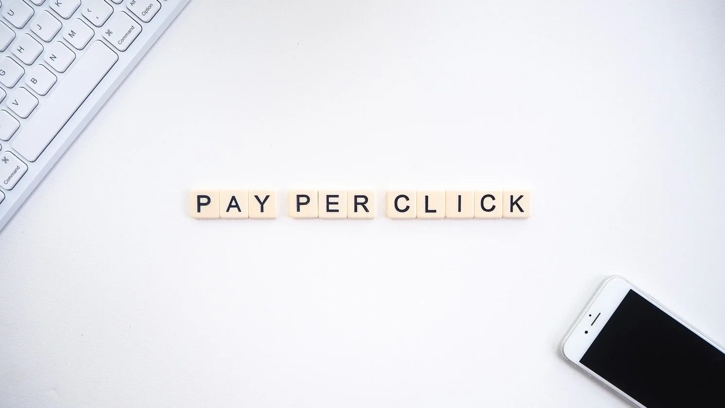 Marketer's finger hovering over a computer mouse, pondering pay-per-click advertising effectiveness