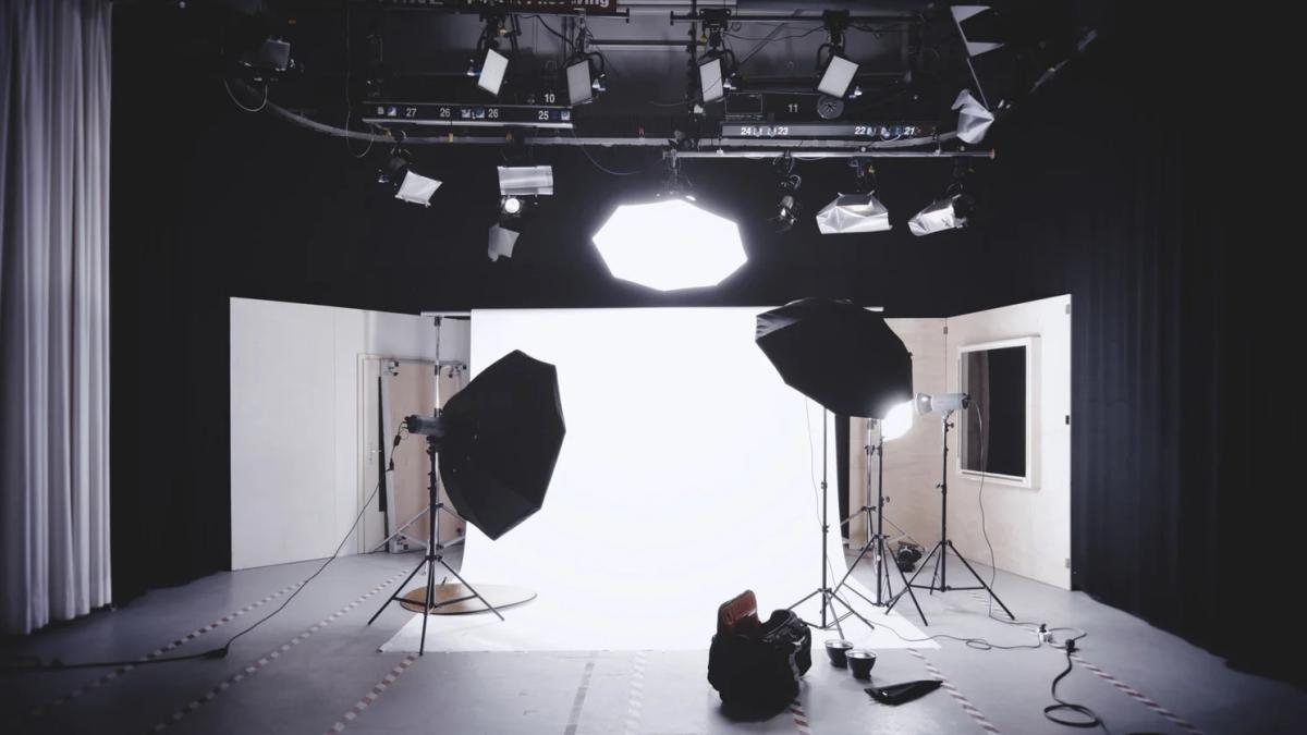 Professional photographer adjusts settings, showcasing quality photography's marketing impact