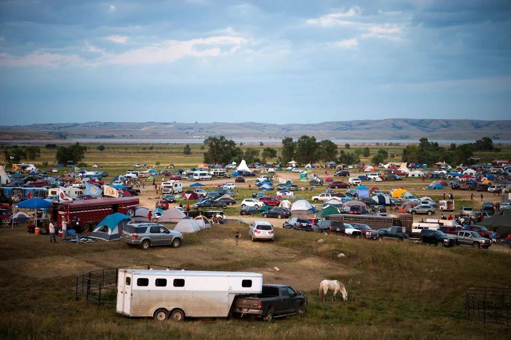 Activists stage a pipeline protest with signs and banners, demonstrating their cause