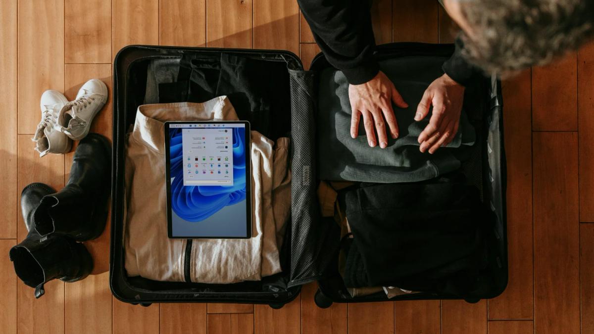 Travel company team brainstorms PR strategies with notes and laptop open