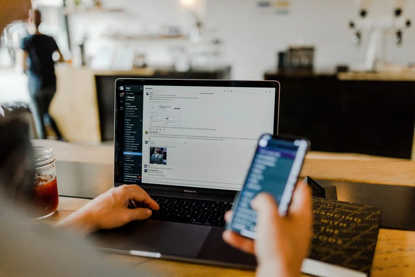 Digital marketing professional generating leads on social media with a laptop and phone