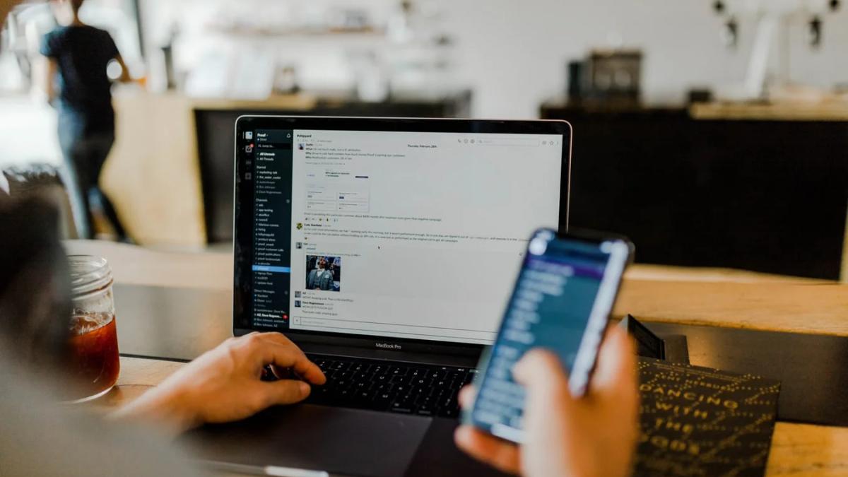 Digital marketing professional generating leads on social media with a laptop and phone