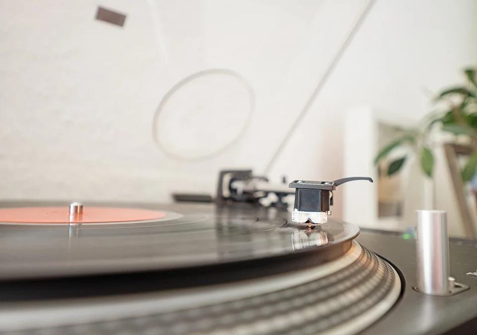 A person holding a vinyl record, illustrating the resurgence of music formats
