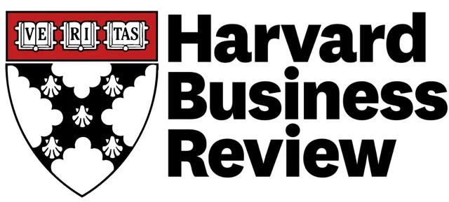 Harvard Business Review magazine resting on an open book and coffee