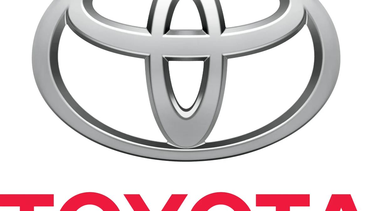 Toyota cars on a dealership lot with open doors, awaiting recall inspection