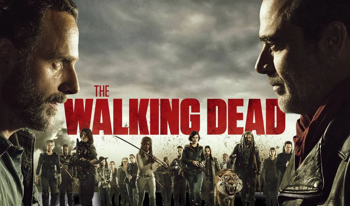 A large group of diverse zombie extras on set, walking together through a city