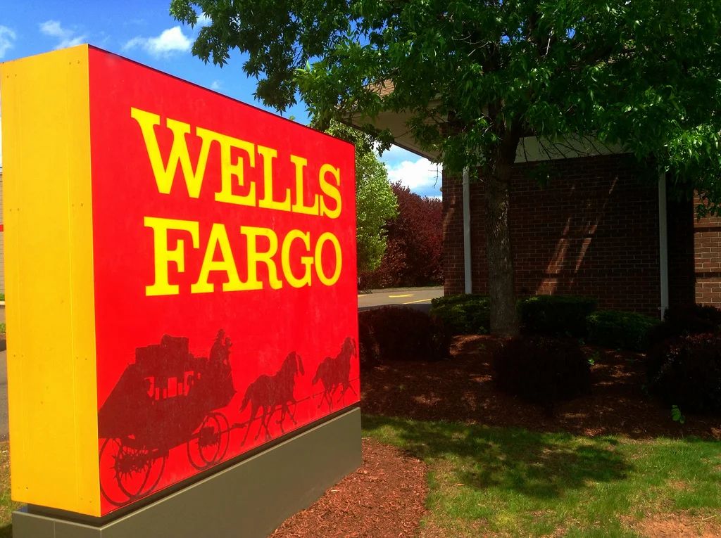 Wells Fargo's crumbling golden stagecoach logo against a dark background